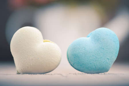macarons in heart shape on wood table,vintage tone styleの写真素材