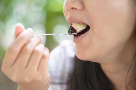 Woman eating Blueberry Cake
