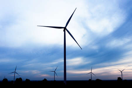 beautiful landscape image with Windturbine farm at the sunrise