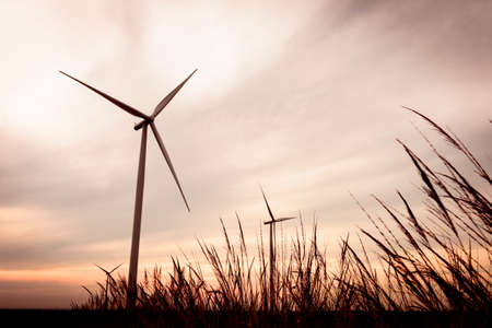 beautiful landscape image with Windturbine farm at the sunsetの写真素材