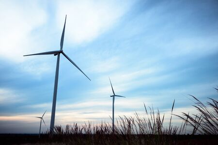 beautiful landscape image with Windturbine farm at the sunrise
