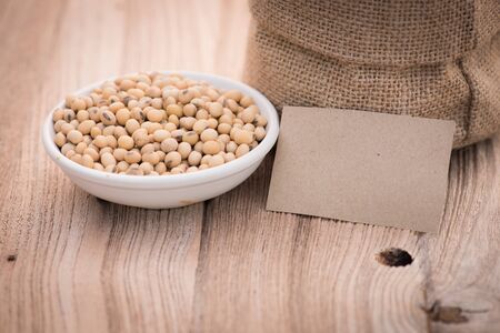 soybeans in ceramic blow on wood tableの写真素材