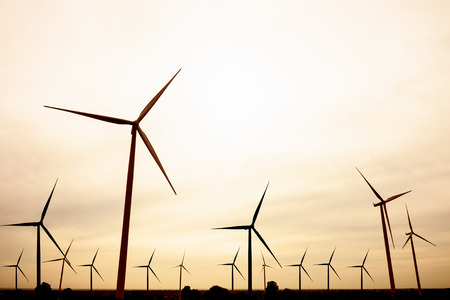 beautiful landscape image with Windturbine farm at the sunset