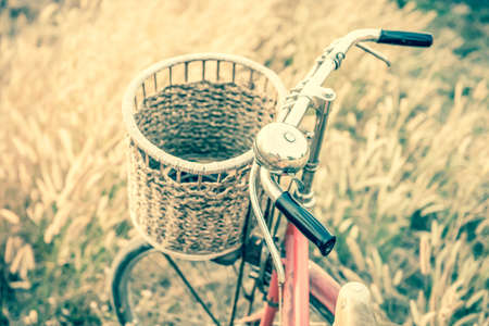 Vintage Bicycle with Summer grassfield in vintage tone styleの写真素材