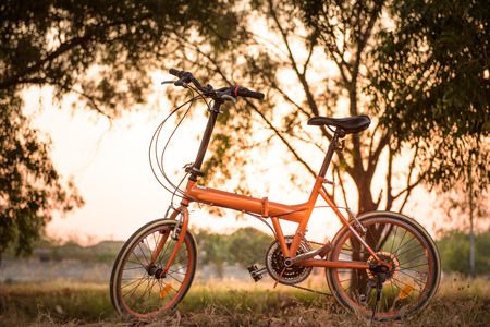 beautiful landscape image with Bicycle at sunsetの写真素材