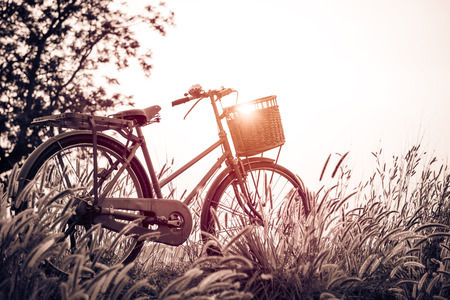 beautiful landscape image with Bicycle at sunset ; vintage filter styleの写真素材