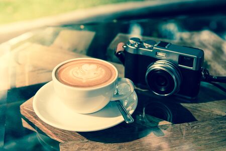 coffee latte art with classic camera  ;vintage tone styleの写真素材