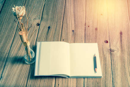 note book with spa decoration on wood table ; vintage filtered tone styleの写真素材