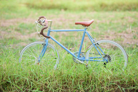beautiful landscape image with sport vintage Bicycle at grass fieldの写真素材