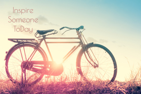 beautiful landscape image with Bicycle at sunset in vintage tone style ; life quote. Inspirational quote. Motivational backgroundの写真素材
