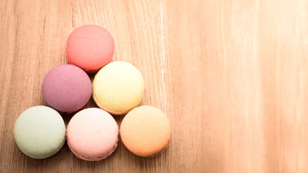 Colorful French Macarons on wooden backgroundの写真素材