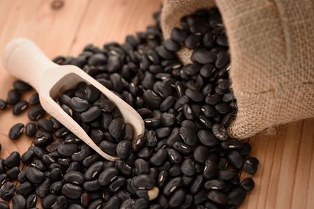 Vigna mungo or black beans with wooden scoopの写真素材