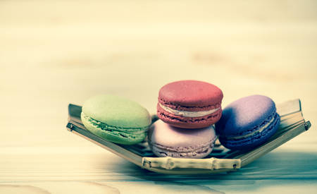Colorful French Macarons on wooden background;vintage tone styleの写真素材