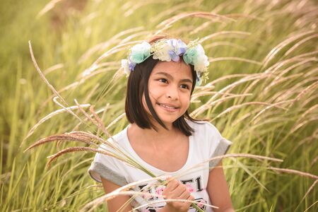 Beautiful asian girl holding glass flowers in a farmの写真素材
