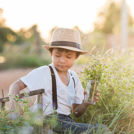 Boy Vintage Style holding flowers and  think of someoneの写真素材