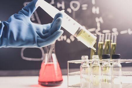 Laboratory research, dropping chemical liquid to test tubes