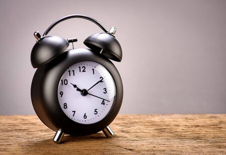Retro black alarm clock with gray background
