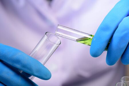 Hands of clinician holding tools during scientific experiment in laboratory