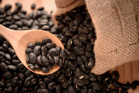 Vigna mungo or black beans in wooden spoon