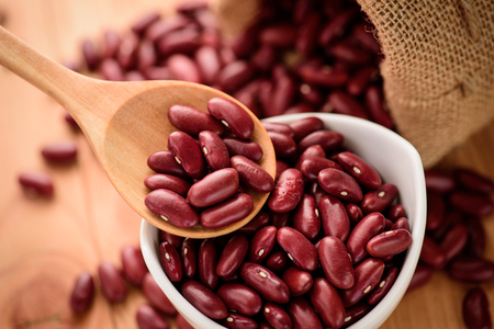 Red Kidney bean in white ceramic bowl and wooden spoonの写真素材