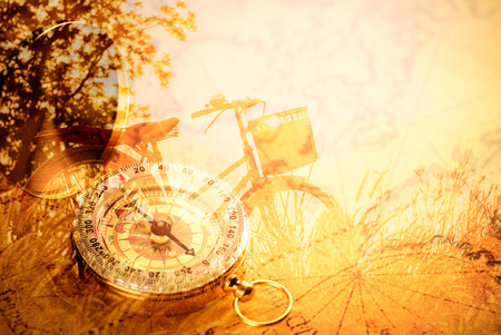 Old  gold vintage compass on vintage map:Heading southの写真素材