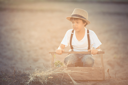 portrait kids with flowergrass in wooden box : vintage tone styleの写真素材