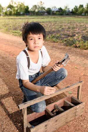 portrait kids with hammer my occupation in the future conceptの写真素材