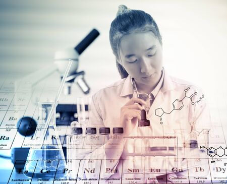 scientist or doctor thinking for writing report with equipment and science experimentsの写真素材