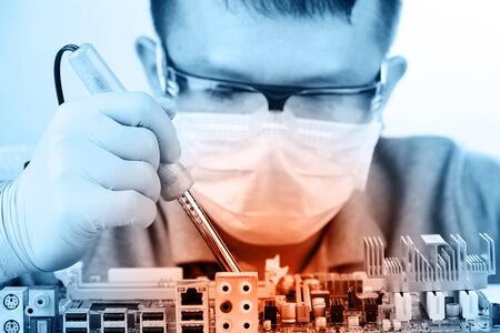 Technological background with closeup on tester checking motherboard. Electronics repair service,...