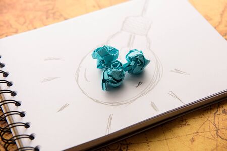 Inspiration concept crumpled paper with light bulb metaphor for good ideaの写真素材