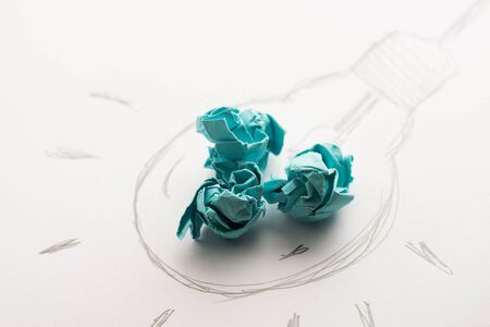 Inspiration concept crumpled paper with light bulb metaphor for good idea