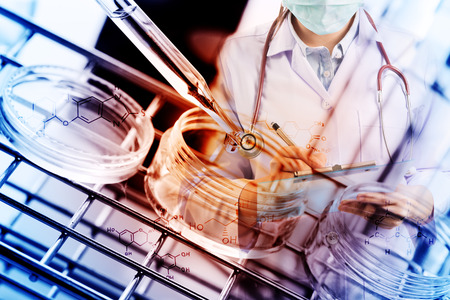 Double exposure of scientist writing report with equipment and science experiments,Laboratory research, dropping liquid to test tube with chemical equationsの写真素材