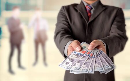 Money in Businessman hand , US dollar,investment, success and profitable business conceptsの写真素材