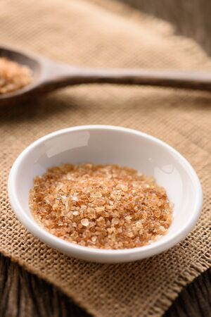Raw Organic Cane Sugar in white ceramic bowlの写真素材