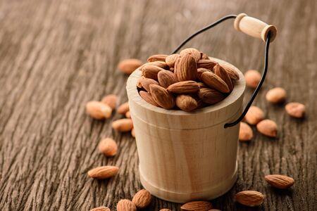Almonds in wood bucketの写真素材