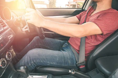 man driving car (control wheel mounted right). Vintage filter process styleの写真素材