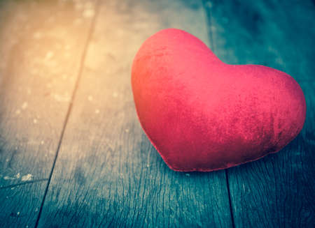 Valentines Day background with hearts on old wood in vintage filter styleの写真素材