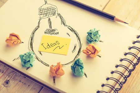 Inspiration concept crumpled paper with light bulb metaphor for good idea,vintage ton styleの写真素材