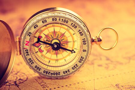 Old  gold vintage compass on vintage mapの写真素材