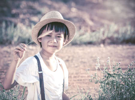 portrait kids keeping flowergrass.vintage porcess styleの写真素材