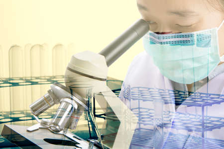 Double exposure of scientist or doctor use microscope with equipment and science experiments...