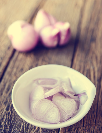 red onions on grung wood background in vintage tone styleの写真素材