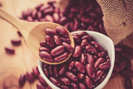 Red Kidney bean in white ceramic bowl and wooden spoonの写真素材