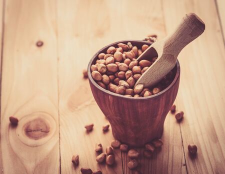 Raw peanuts or arachis in ceramic bowlの写真素材