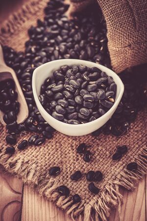 Vigna mungo or black beans with wooden spoonの写真素材