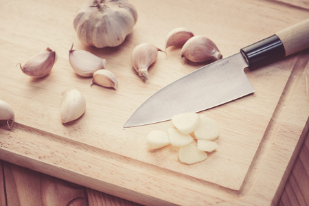 garlic on wood blockの写真素材