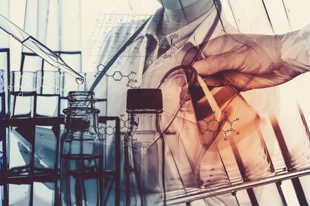 Laboratory glassware containing chemical liquid, science research,Double exposure of scientist and test tubes, laboratory conceptの写真素材