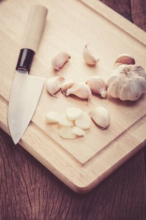 garlic on wood blockの写真素材
