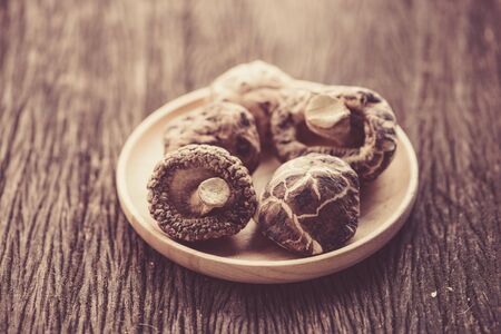 dried shiitake mushroom in wood bowlの写真素材