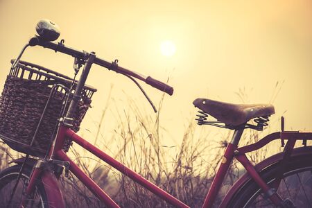 beautiful landscape image with vintage Bicycle at sunset ; vintage tone styleの写真素材